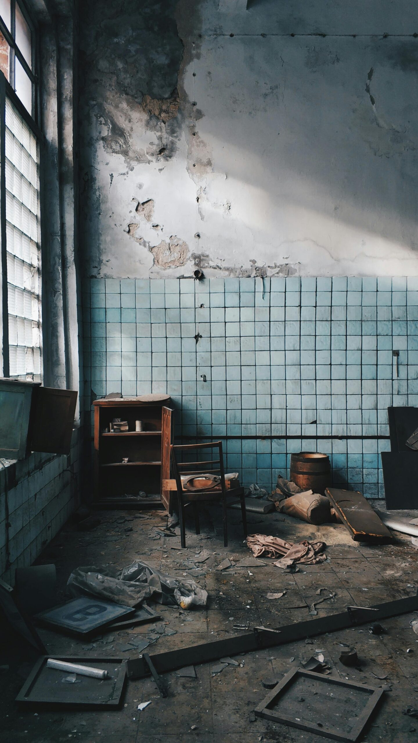 An abandoned room with debris and old furniture, in need of junk removal services.