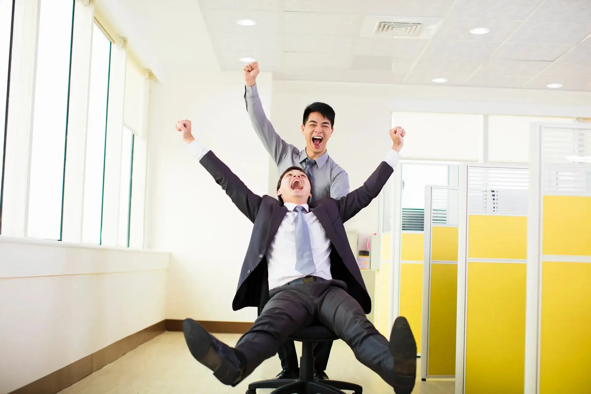 Colleagues celebrating a successful office move in Sydney with joyful enthusiasm.